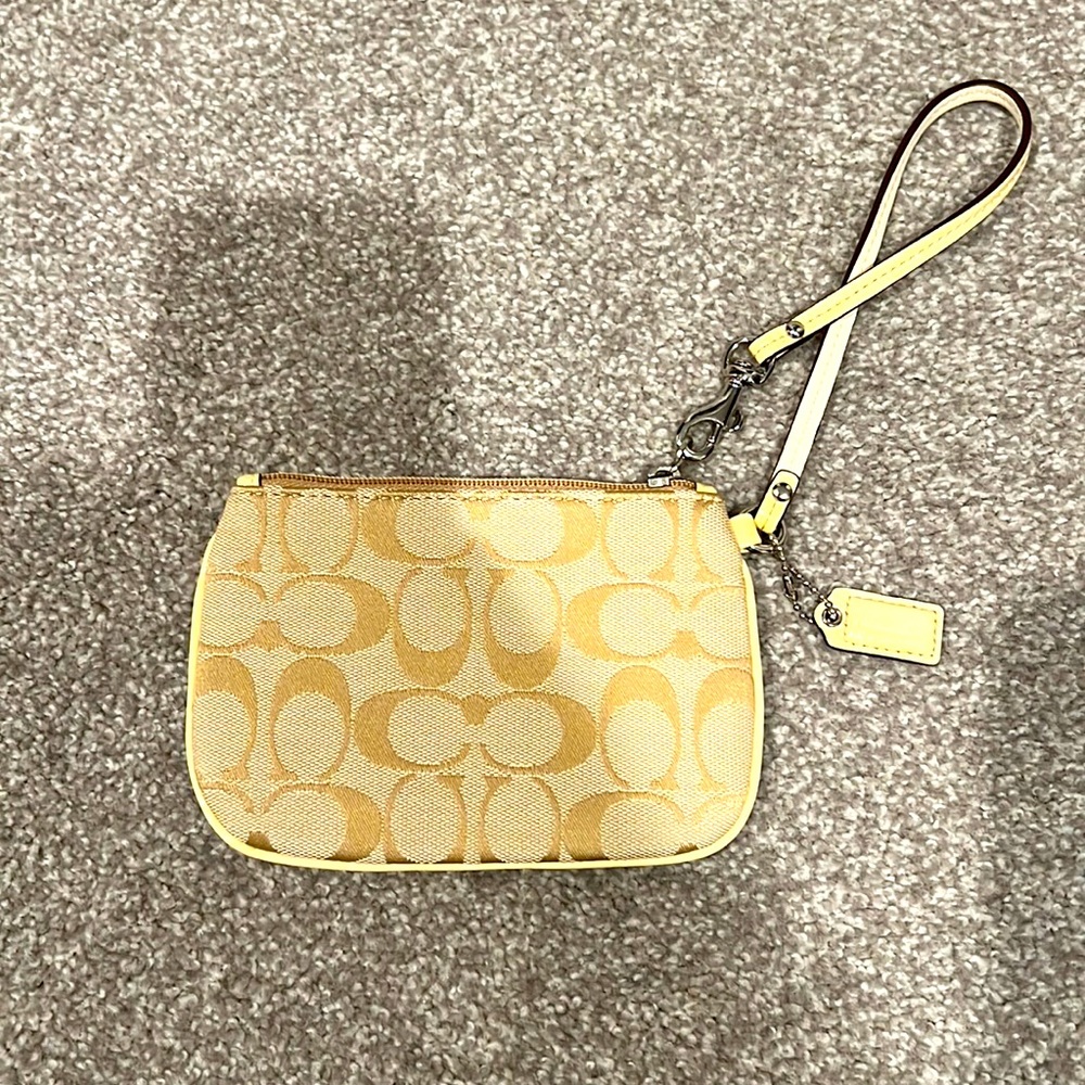 Coach wristlet in pastel yellow. New with dust bag. No tags Perfect for Easter!